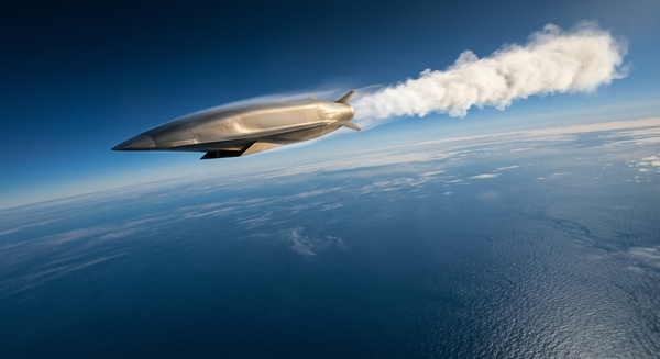 A hypersonic strike missile in flight across the upper atmosphere above the ocean